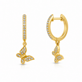 A pair of gold huggie hoop earrings with a vertical bar studded with small clear stones and a dangling butterfly charm, shown on a plain white background.