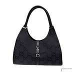 Black handbag with a prominent brand logo on a white background