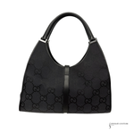 Black handbag with Gucci logo pattern on a white background