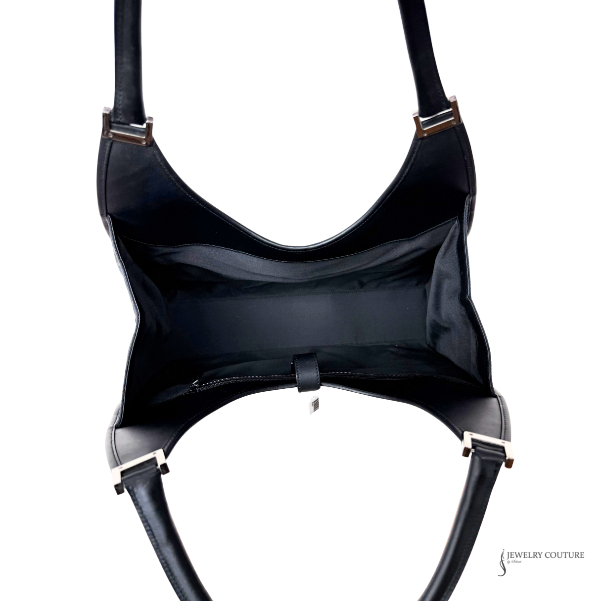 Black leather harness with gold hardware on a white background