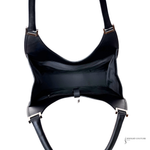 Black leather harness with gold hardware on a white background