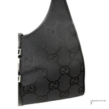 Black handbag with a pattern on a white background