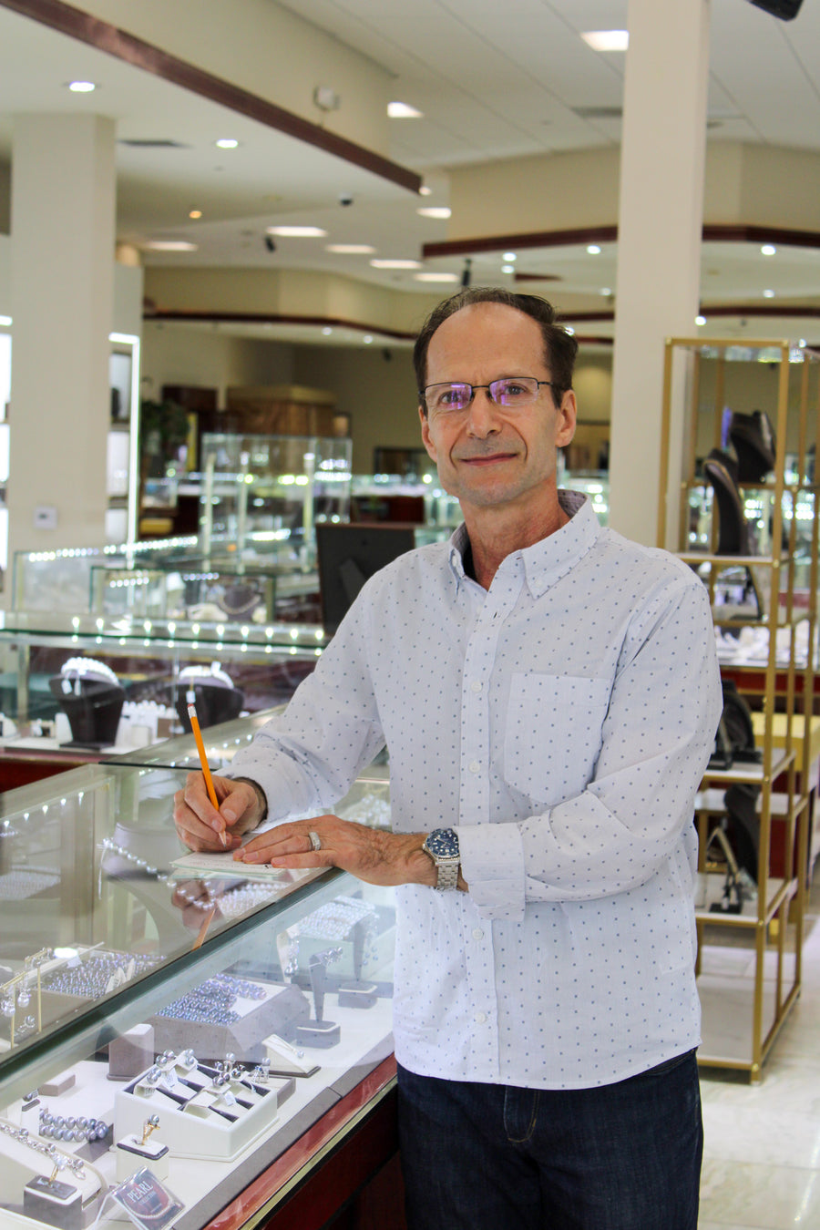 Jewelry Couture jeweler at a showroom display case