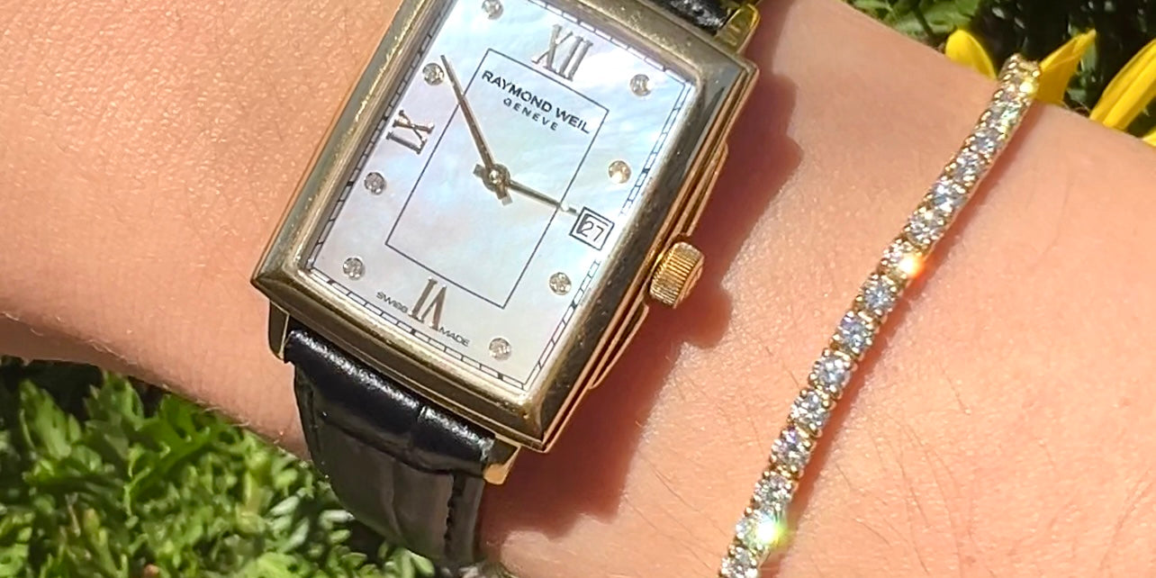 Raymond Weil Cartier style watch mother of pearl and bracelet strap black leather wrist with floral background and a tennis bracelet