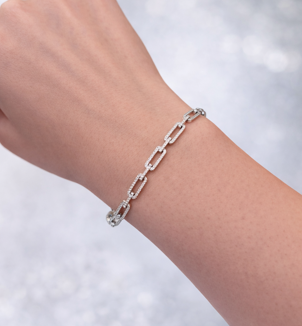 14KT White Gold and Diamond Bracelet chain bracelet on a wrist with a blurred light background