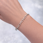 14KT White Gold and Diamond Bracelet chain bracelet on a wrist with a blurred light background
