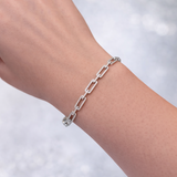 14KT White Gold and Diamond Bracelet chain bracelet on a wrist with a blurred light background