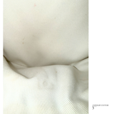 Close-up of textured white fabric with 'Jewelry Couture' branding.