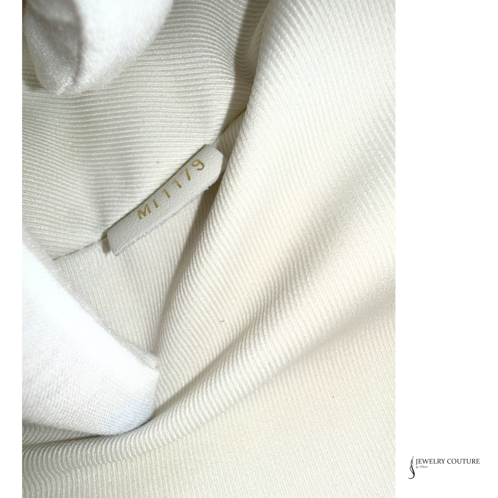 Close-up of a textured fabric with a brand label on a white background