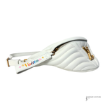 White quilted handbag with gold accents and colorful 'Louis Vuitton' logo on a white background.