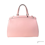Pink handbag with silver accents on a white background
