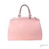 Pink handbag with silver accents on a white background
