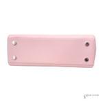 Pink wallet with silver buttons on a white background