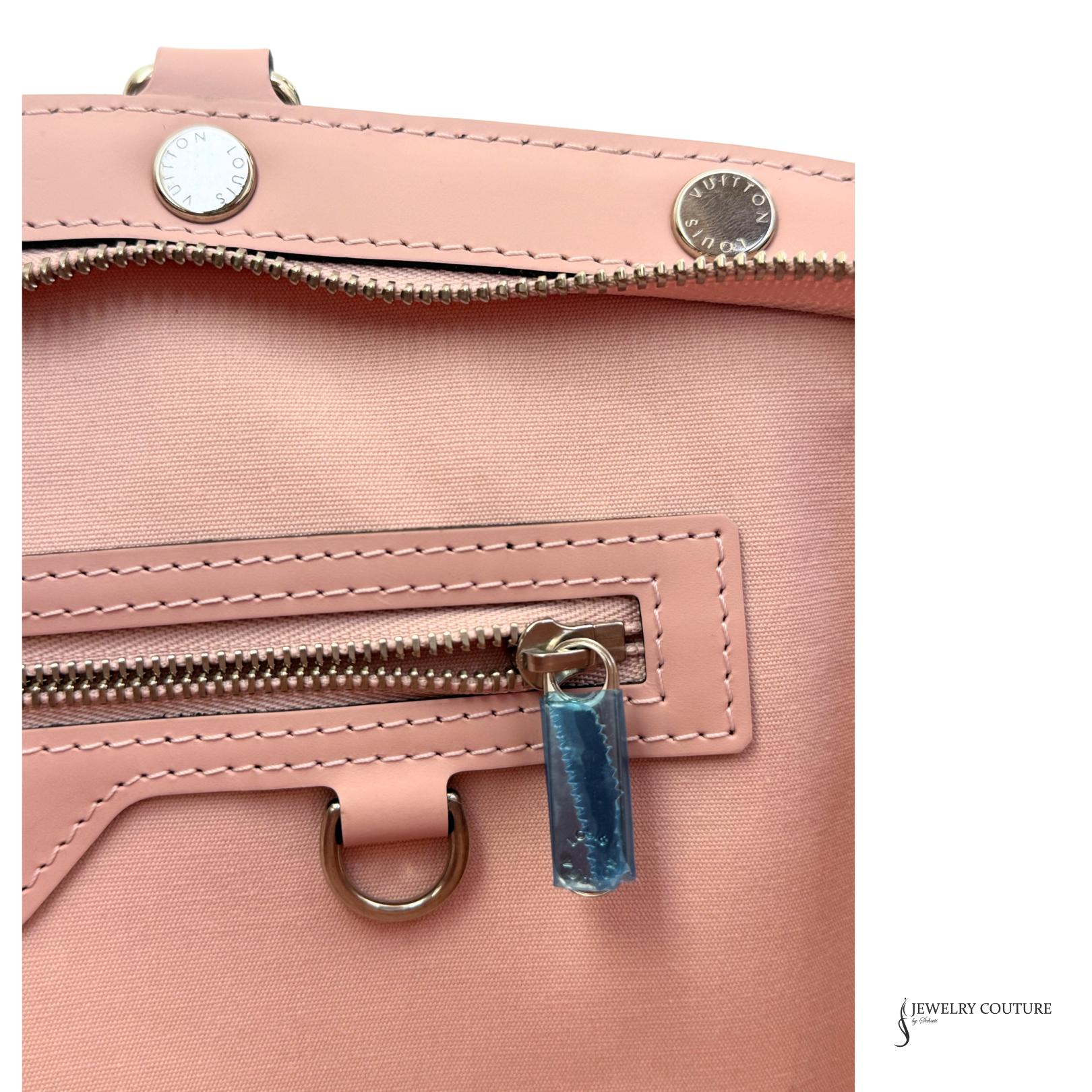 Close-up of a pink handbag with a blue tag and 'Jewelry Couture' branding.