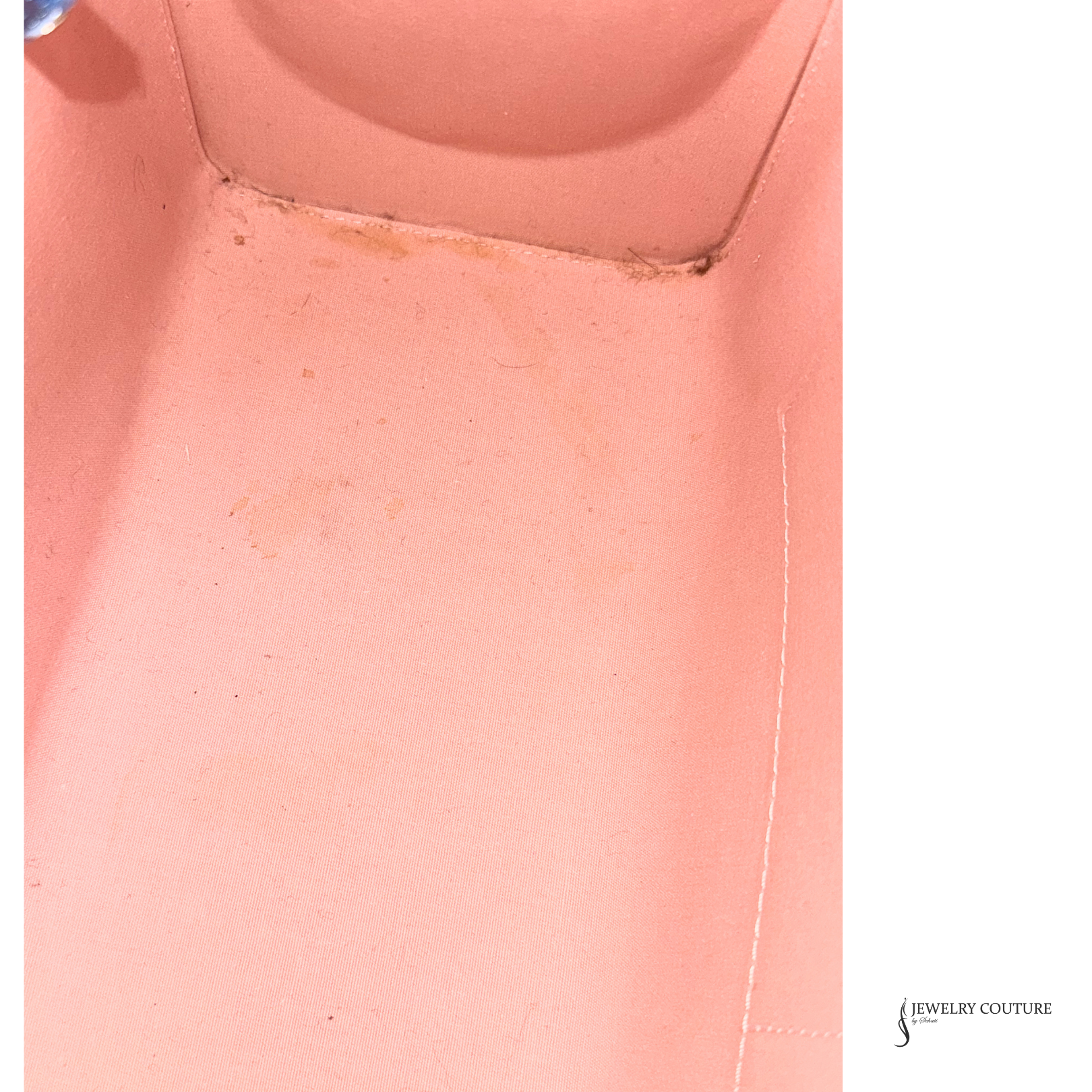 Close-up of a pink fabric with visible wear and tear, branded 'Jewelry Couture'.