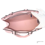 Pink handbag with a white glove on a white background