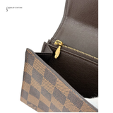 Brown checkered pouch with gold zipper on a white background