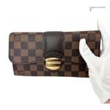 Louis Vuitton wallet with checkered pattern held by a gloved hand on a white background