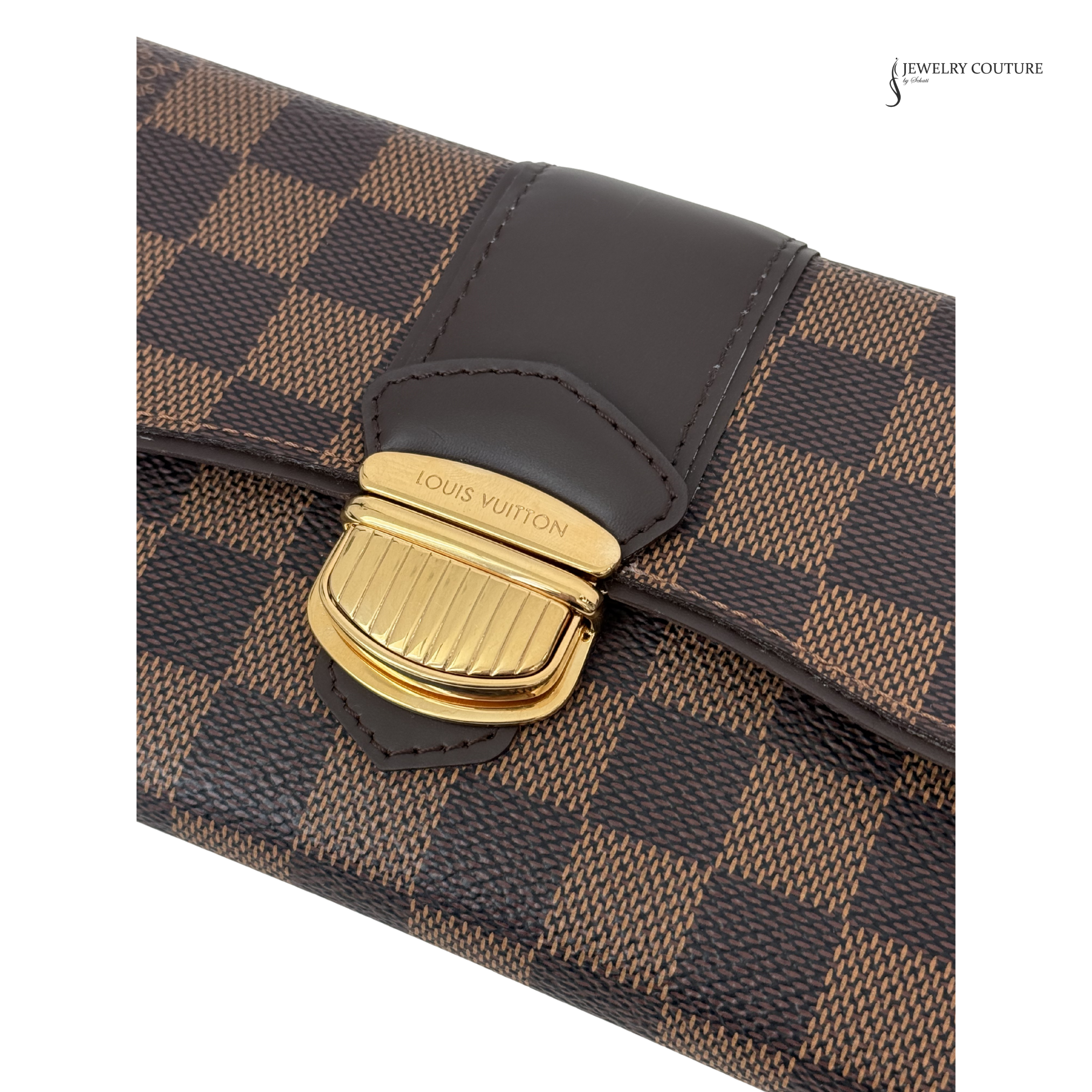 Close-up of a Louis Vuitton handbag with gold clasp on a white background