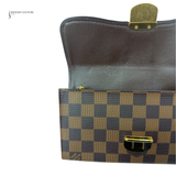 Two pouches, one with a gold clasp and checkered pattern, on a white background.
