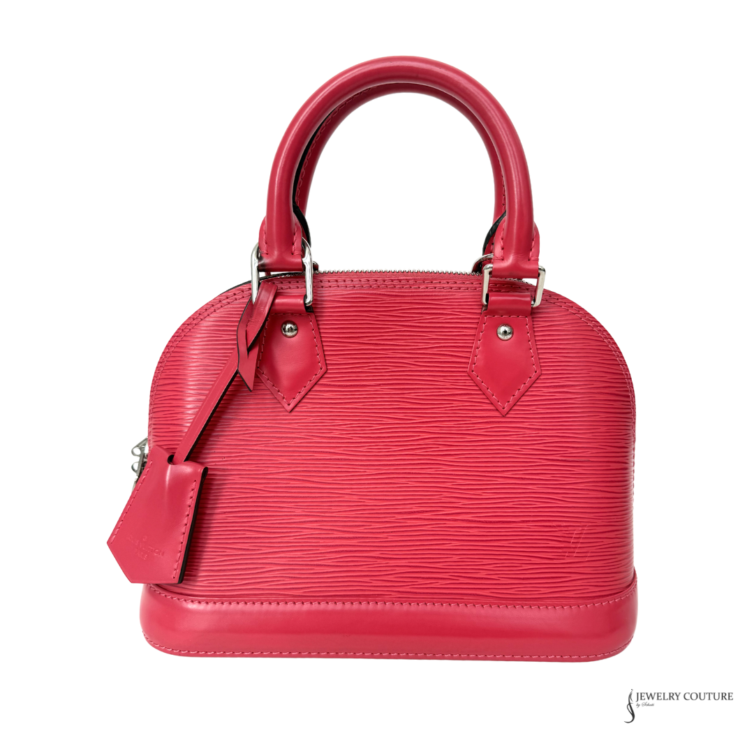 Red handbag with a strap on a white background