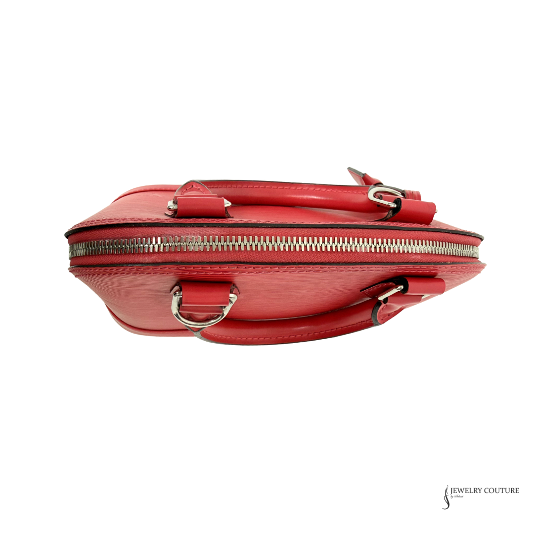 Red handbag with gold zipper and hardware on a white background