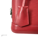 Close-up of a red Louis Vuitton handbag with visible branding.