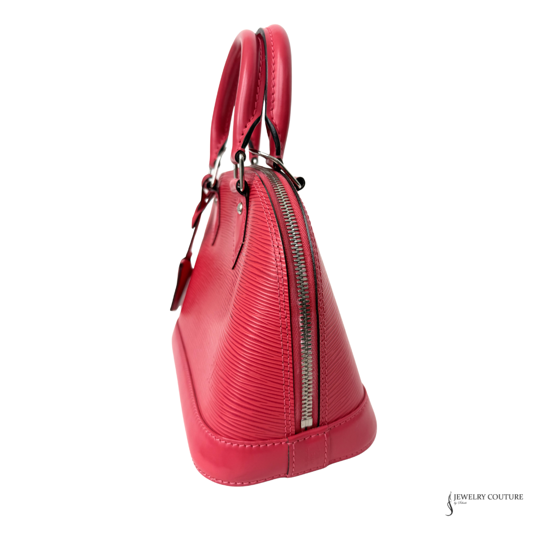 Red handbag with a visible brand logo on a white background