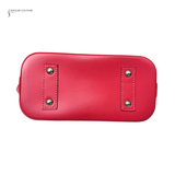 Red handbag with silver studs on a white background