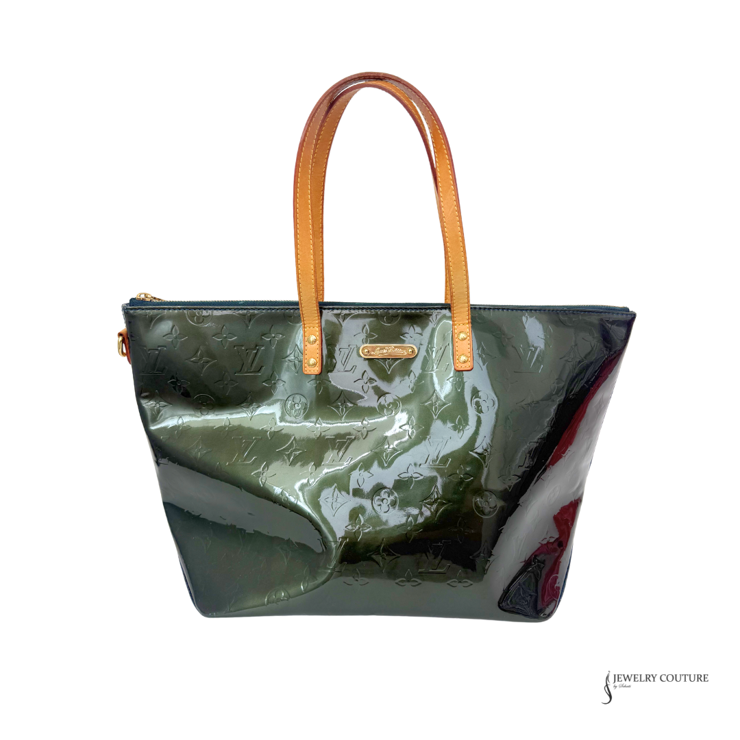 Green handbag with brown handle on a white background
