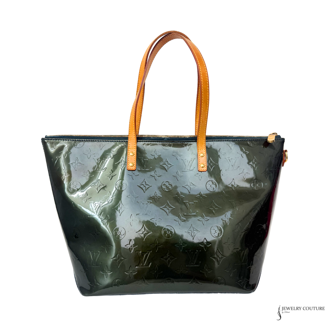 Green patent leather handbag with brown handles on a white background
