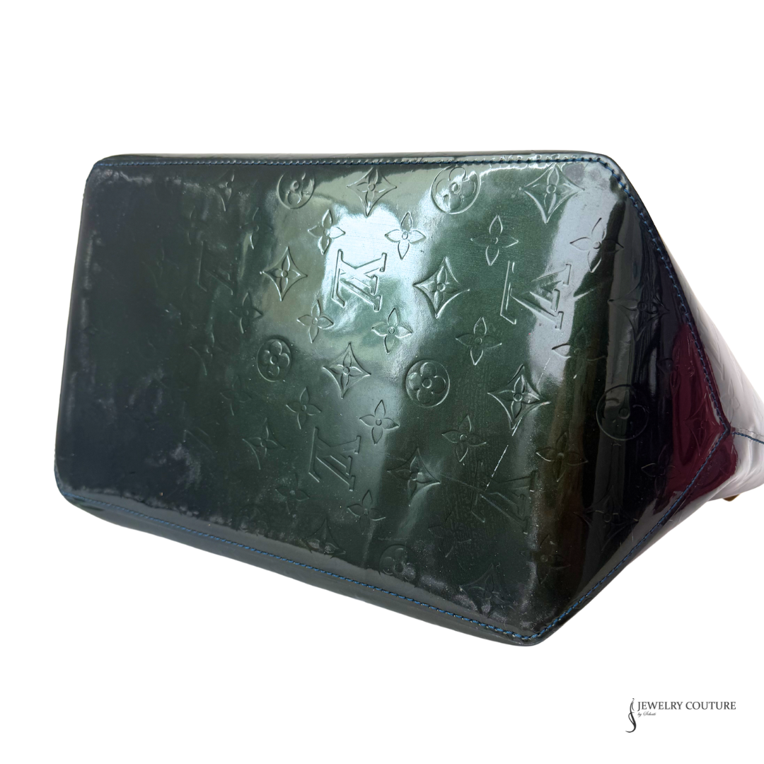 Green wallet with monogram pattern on a white background