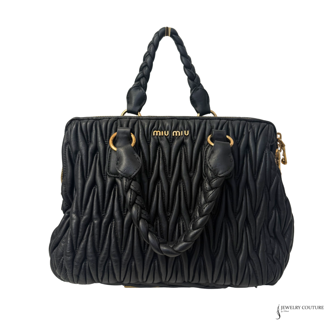 Black quilted MIU MIU  handbag with braided handle on a white background
