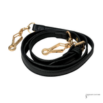 Black leather dog leash with gold hardware on a white background