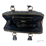 Black handbag with gold accents on a white background