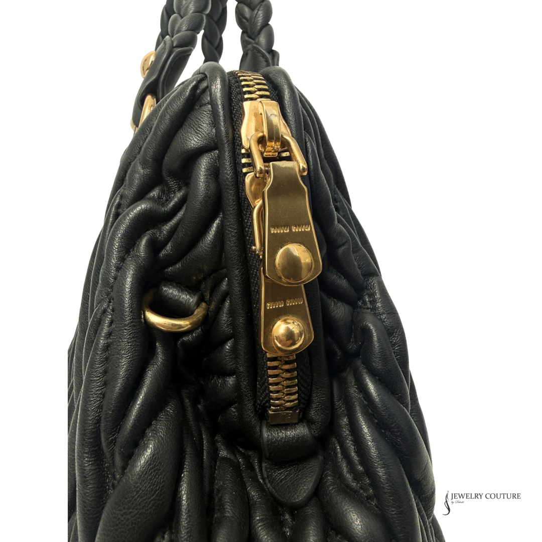 Black textured handbag with gold hardware on a white background