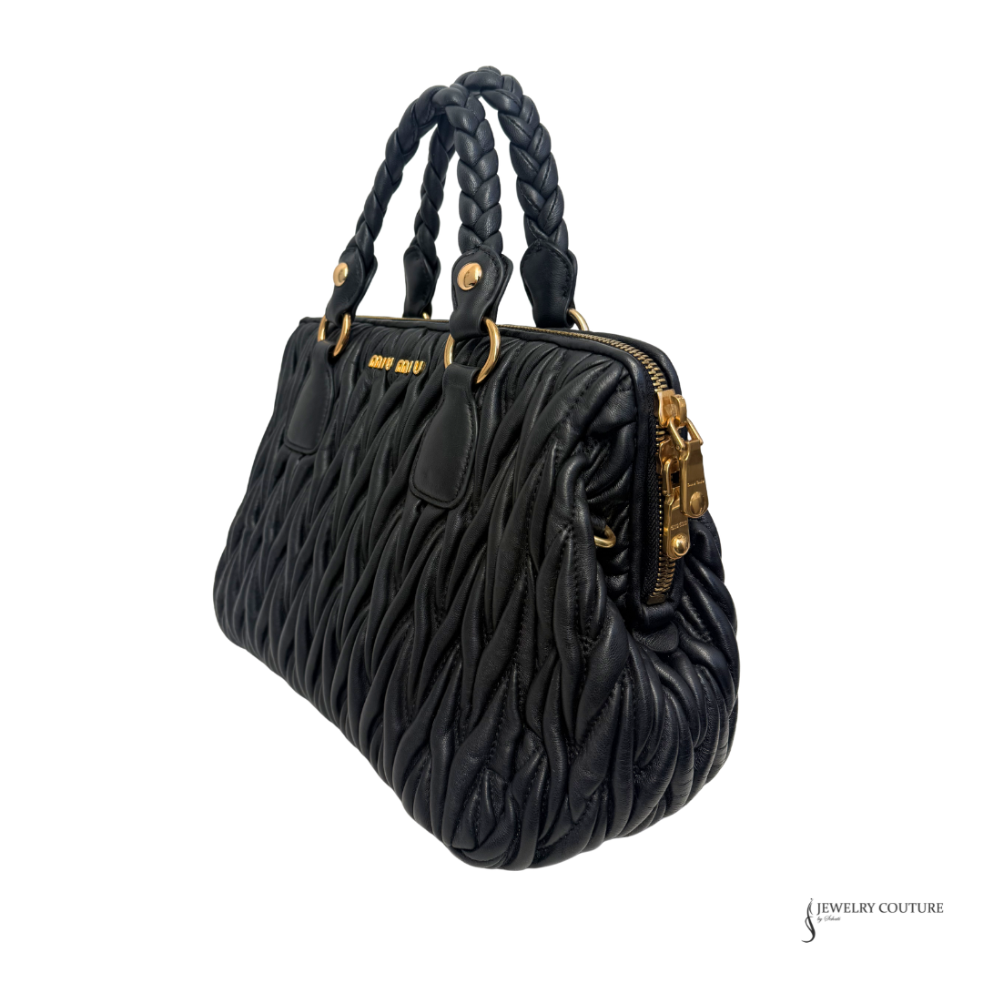 Black textured handbag with braided handles on a white background