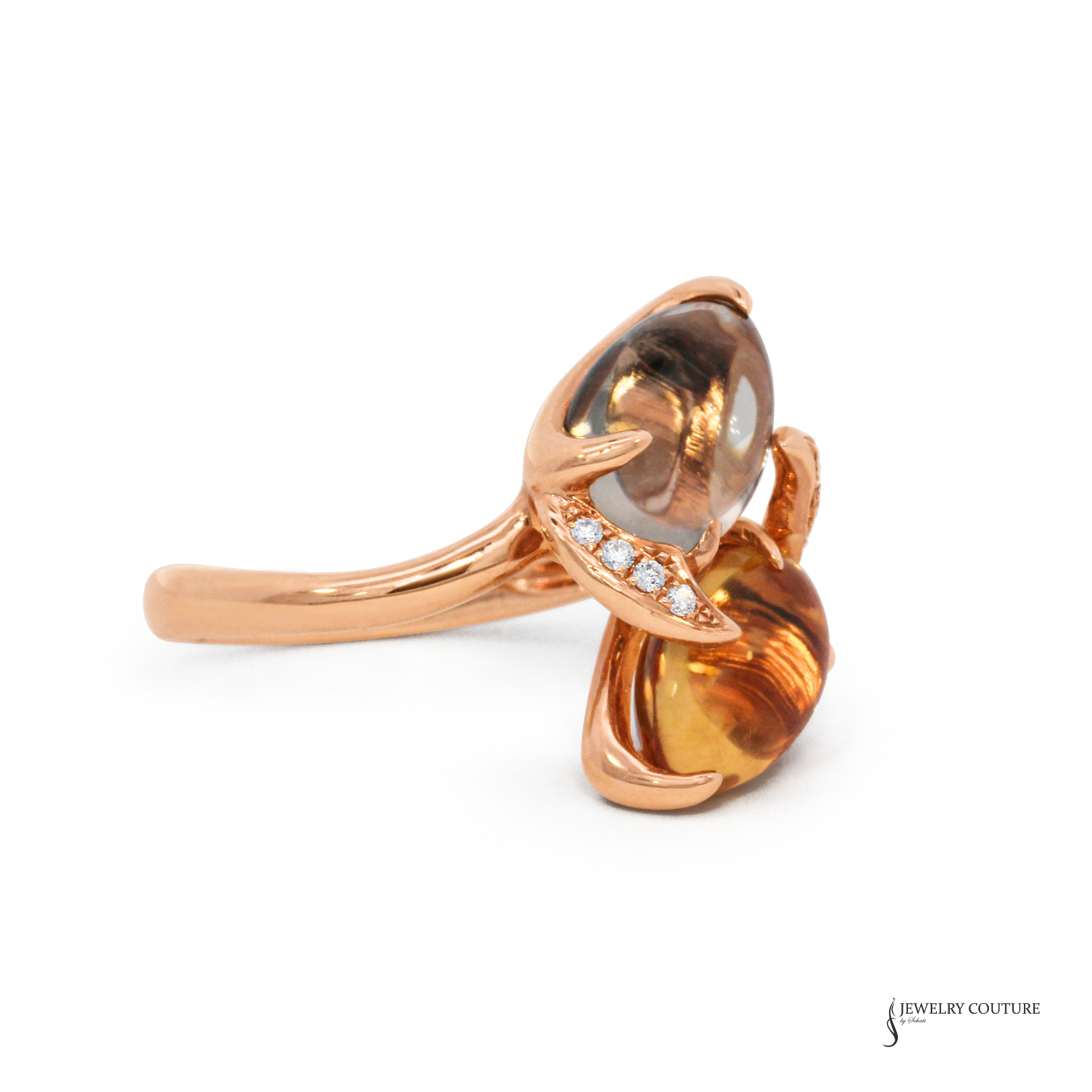 Rose gold ring with a large brown gemstone and smaller clear stones on a white background