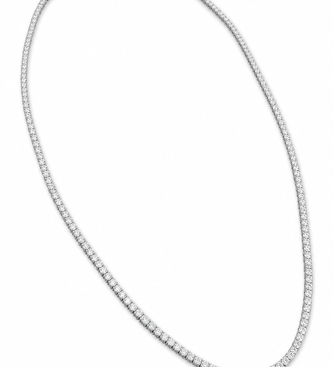 A tennis-style diamond necklace in a white-toned metal, arranged in an oval shape on a plain white background.