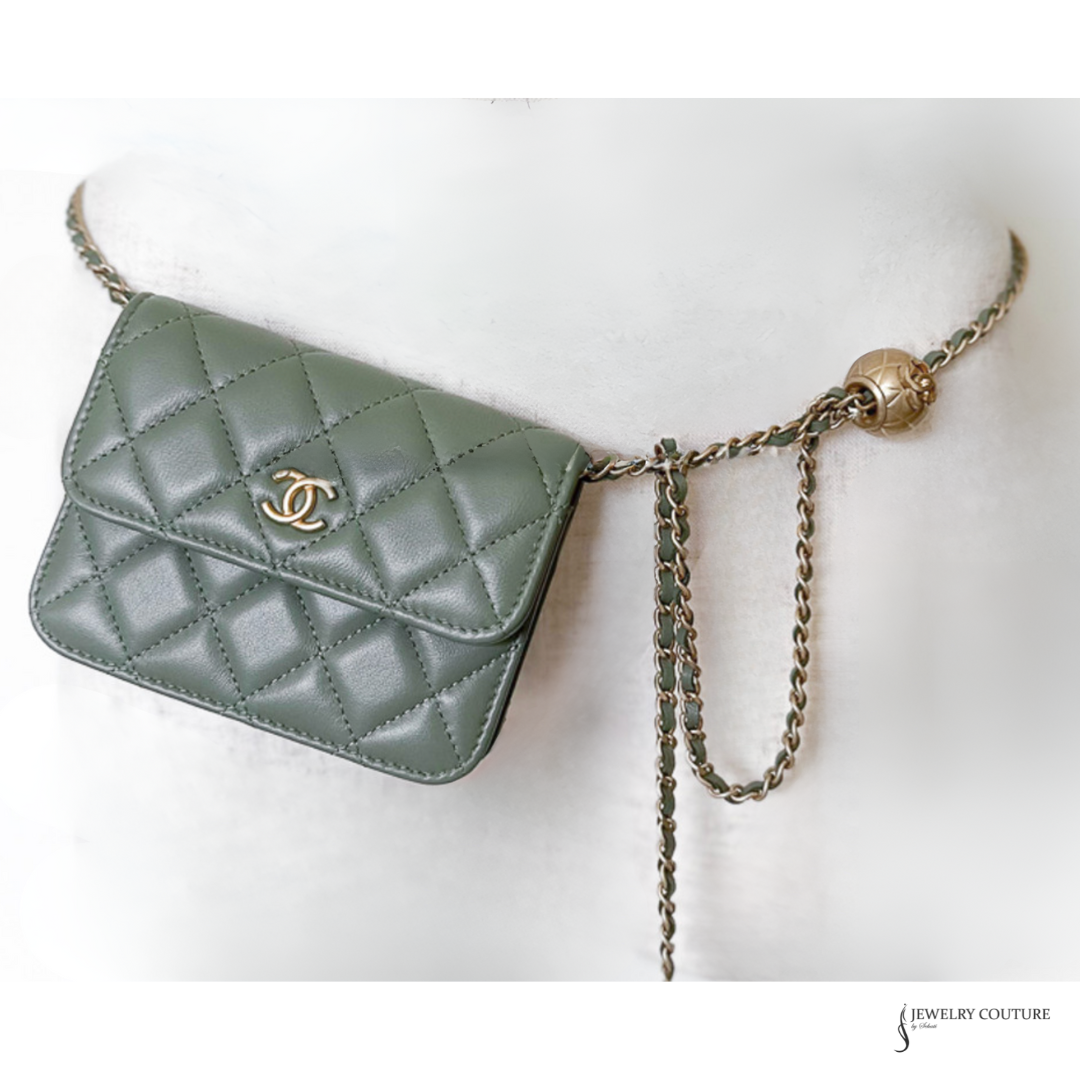 Green quilted handbag with chain strap on a white background