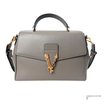 Gray handbag with gold emblem on a white background
