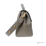 Gray handbag with gold accents on a white background