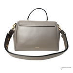Gray handbag with gold accents on a white background