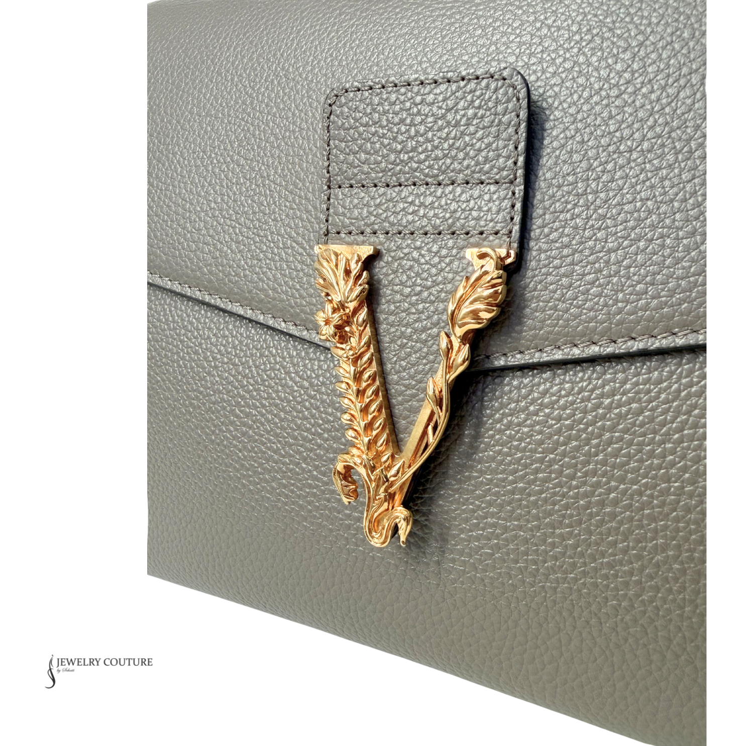 Gray textured handbag with a gold emblem on a white background