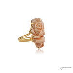 Carved angel skin coral rose ring in 14K gold prongs with split shank, angled view