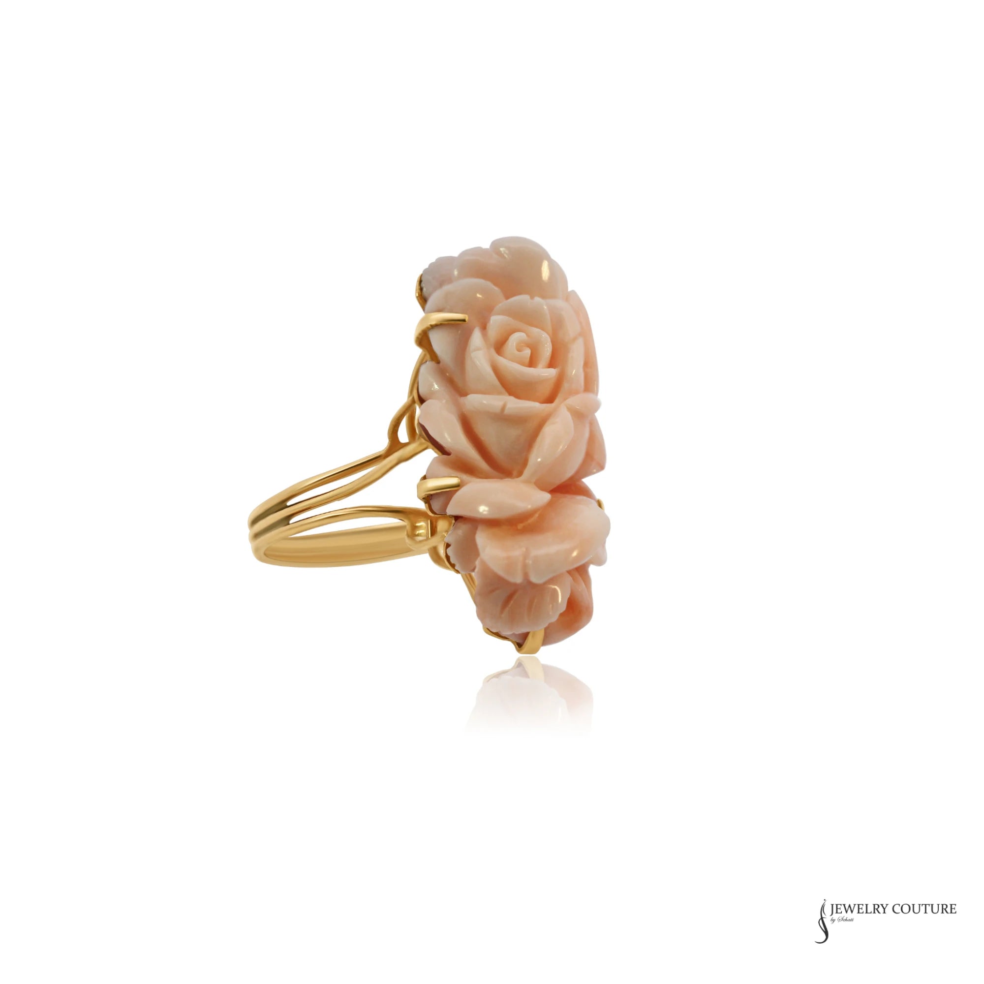 Carved angel skin coral rose ring in 14K gold prongs with split shank, angled view