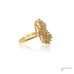 Side profile of diamond cluster ring showing raised tiered prongs and 14K yellow gold shank