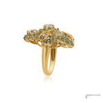 Side profile of topaz cluster ring showing raised 18K gold openwork scroll gallery and polished shank