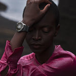 Person wearing a watch with a blurred background