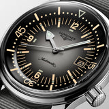 Longines watch with black dial and silver case on a light gray background